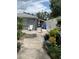 A fenced backyard with potted plants, and some exterior parts of the house at 7022 Hubert, Tampa, FL 33614