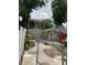 View of the backyard with a storage shed and greenery through a chain-link gate at 7022 Hubert, Tampa, FL 33614