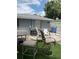 Fenced backyard with outdoor seating, artificial turf, and an air conditioning unit at 7022 Hubert, Tampa, FL 33614