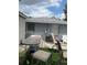 Fenced backyard with outdoor seating, artificial turf, and an air conditioning unit at 7022 Hubert, Tampa, FL 33614