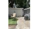 Cozy backyard space with artificial turf, seating, and an air conditioning unit at 7022 Hubert, Tampa, FL 33614