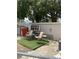 Cozy backyard space with artificial turf, seating, and an air conditioning unit at 7022 Hubert, Tampa, FL 33614
