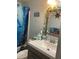 Nautical themed bathroom features a sink and mirror with decorative vines and shells at 7022 Hubert, Tampa, FL 33614
