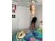 A bedroom features sliding closet doors and ceiling fan with playful character-themed linens at 7022 Hubert, Tampa, FL 33614