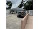 Exterior view of a home, showcasing its driveway, muted color scheme and proximity to additional parking at 7022 Hubert, Tampa, FL 33614