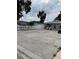 Street view showing the home's neutral color scheme, expansive driveway, and easy access parking at 7022 Hubert, Tampa, FL 33614