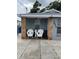 Inviting front porch with decorative rock columns and seating creating a warm, welcoming entrance at 7022 Hubert, Tampa, FL 33614