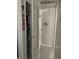 Hallway view of a storage closet and a door with white tile flooring throughout at 7022 Hubert, Tampa, FL 33614