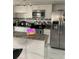 Modern kitchen with granite counters, stainless steel appliances, and ample storage within bright, white cabinetry at 7022 Hubert, Tampa, FL 33614