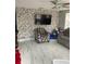 Cozy living room highlights a stone accent wall and plush seating under a cooling ceiling fan at 7022 Hubert, Tampa, FL 33614