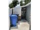 View of the side yard space with a blue garbage can and entrance into a shed or utility area at 7022 Hubert, Tampa, FL 33614