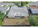 Aerial view of the home showcasing the layout, fenced backyard, and a partially covered patio at 7040 Fox Hollow Dr, Port Richey, FL 34668