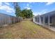 Backyard featuring a wooden fence, partially covered patio, and an AC unit at 7040 Fox Hollow Dr, Port Richey, FL 34668