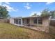 Backyard with partially covered patio and an AC unit at 7040 Fox Hollow Dr, Port Richey, FL 34668
