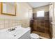 Tiled bathroom featuring white vanity and step-in shower at 7040 Fox Hollow Dr, Port Richey, FL 34668