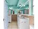 Bright bathroom with dual vanities, tile floors, and decorative mirrors at 7040 Fox Hollow Dr, Port Richey, FL 34668