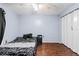 This bedroom has wood floors and lots of natural light at 7040 Fox Hollow Dr, Port Richey, FL 34668