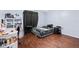 This cozy bedroom features wood floors and ample space for storage at 7040 Fox Hollow Dr, Port Richey, FL 34668