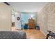 Bright bedroom featuring textured wall and a view of the hallway at 7040 Fox Hollow Dr, Port Richey, FL 34668