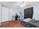 This bedroom includes wood floors and a ceiling fan at 7040 Fox Hollow Dr, Port Richey, FL 34668