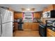 Bright kitchen featuring warm wood cabinets and modern black appliances at 7040 Fox Hollow Dr, Port Richey, FL 34668