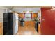 Cozy kitchen featuring warm wood cabinets and stainless steel appliances at 7040 Fox Hollow Dr, Port Richey, FL 34668