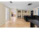 Inviting living room featuring wood floors and plenty of natural light at 7040 Fox Hollow Dr, Port Richey, FL 34668
