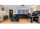 Home living room with wooden floors, a decorative door, and a gray sofa at 7040 Fox Hollow Dr, Port Richey, FL 34668