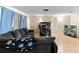 Home living room with wooden floors, a gray sofa, and a television at 7040 Fox Hollow Dr, Port Richey, FL 34668