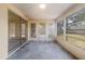 The sunroom has multiple windows, a ceiling fan, and backyard views at 7040 Fox Hollow Dr, Port Richey, FL 34668