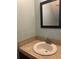 Bathroom sink with mosaic counter-top, mirror and pale green walls at 7192 E Bank Dr, Tampa, FL 33617