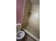 Bathroom featuring a toilet and a shower with a showerhead and metal shelving unit at 7192 E Bank Dr, Tampa, FL 33617