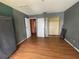 Bedroom with hardwood floors, closet, and access to other rooms at 7192 E Bank Dr, Tampa, FL 33617
