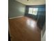 Bedroom with wood-look flooring, a neutral wall color, and bright natural light at 7192 E Bank Dr, Tampa, FL 33617