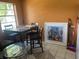 Orange dining room with a table and unique framed artwork at 7192 E Bank Dr, Tampa, FL 33617