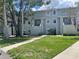 Exterior of Building 7 with green lawn and healthy, flowering trees at 7192 E Bank Dr, Tampa, FL 33617