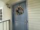 Charming blue front door with a decorative floral wreath at 7192 E Bank Dr, Tampa, FL 33617