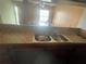 Kitchen sink with stainless steel basins and tiled countertops at 7192 E Bank Dr, Tampa, FL 33617