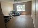 Spacious, empty living room with a window view and plank flooring at 7192 E Bank Dr, Tampa, FL 33617
