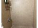 Tiled shower with a hand-held shower head and a built-in metal rack on the side wall at 7192 E Bank Dr, Tampa, FL 33617