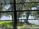 A serene view of a lake through a large window at 7192 E Bank Dr, Tampa, FL 33617