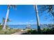Expansive waterfront view showcases clear blue water, city skyline, and palm trees, creating a tranquil vista at 720 Boca Ciega Isle Dr, St Pete Beach, FL 33706