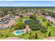 Aerial view of community featuring a pool, pond and lush green spaces, offering a serene living environment at 7614 Radcliffe Cir # 202B, Port Richey, FL 34668