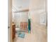 Bathroom with tiled walls, glass shower, and wooden vanity at 7614 Radcliffe Cir # 202B, Port Richey, FL 34668