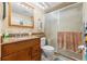 Bathroom featuring a sliding glass shower door, wooden vanity, and granite countertop at 7614 Radcliffe Cir # 202B, Port Richey, FL 34668