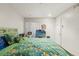 Bright bedroom featuring light walls and a unique patterned bedspread at 7614 Radcliffe Cir # 202B, Port Richey, FL 34668