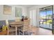 Dining area with hardwood floors, adjacent to sliding glass doors at 7614 Radcliffe Cir # 202B, Port Richey, FL 34668
