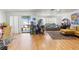 Open-concept living room with sliding glass doors, hardwood floors, and unique decor at 7614 Radcliffe Cir # 202B, Port Richey, FL 34668