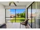 A screened-in porch features a view of the community lawn, enhancing the outdoor living experience at 7614 Radcliffe Cir # 202B, Port Richey, FL 34668