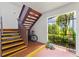 Stairwell leading to upper units showcases accessibility features, with gated entry to lush outdoor area at 7614 Radcliffe Cir # 202B, Port Richey, FL 34668